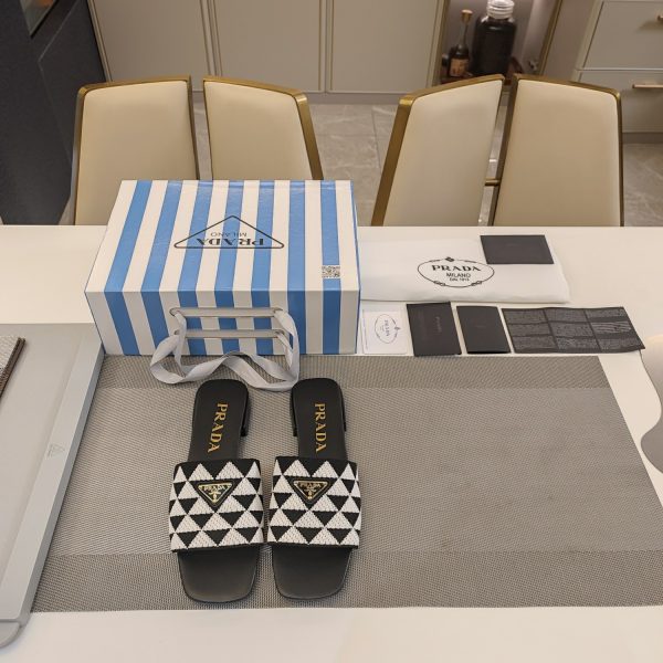 The Prada woven stretch upper is embellished with a two-tone metal buckle with the iconic logo A